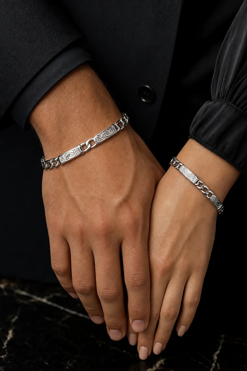 Luxury close-up of matching engraved bracelets on intertwined wrists