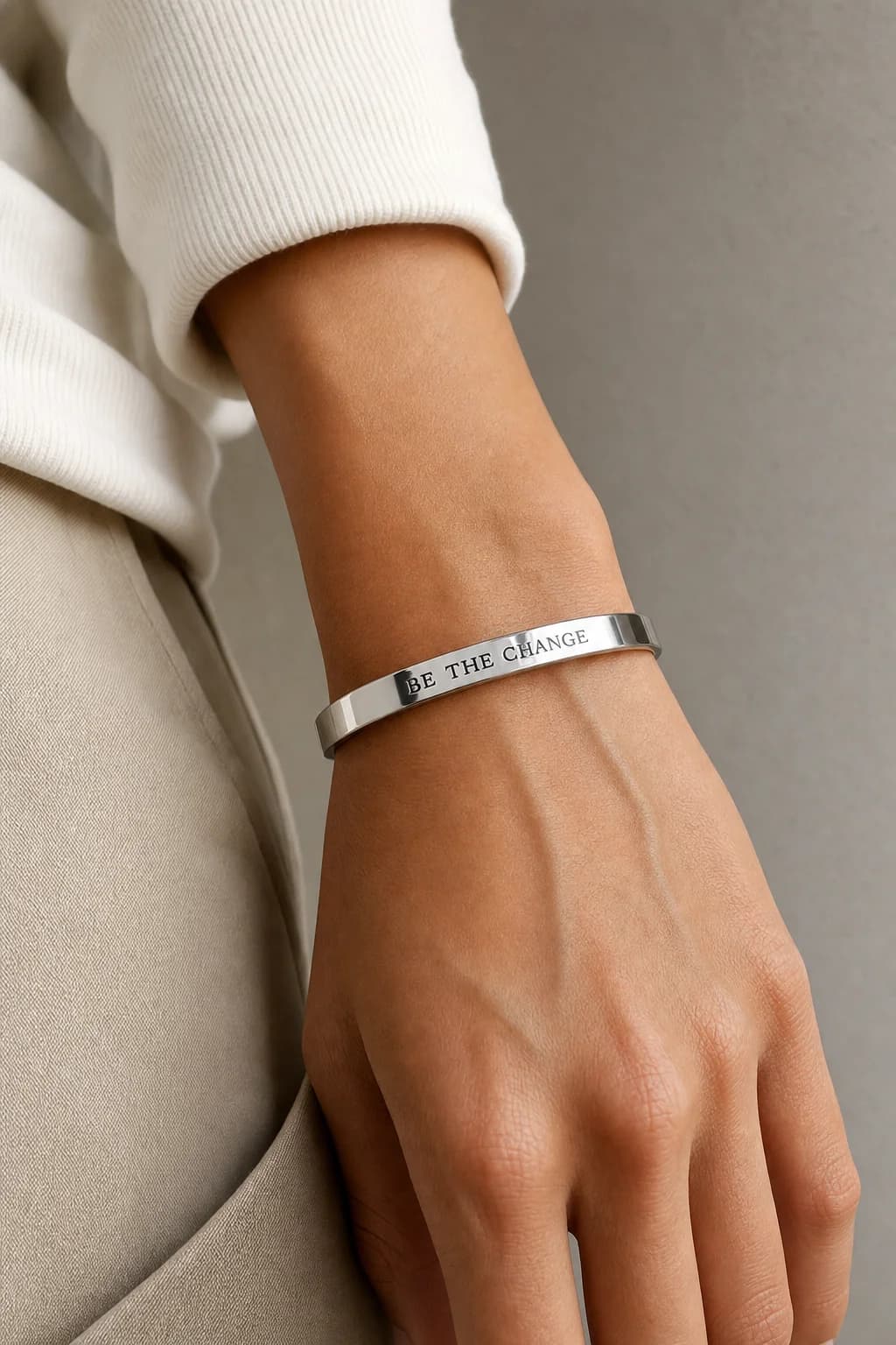 Polished silver cuff bracelet in a luxury studio portrait