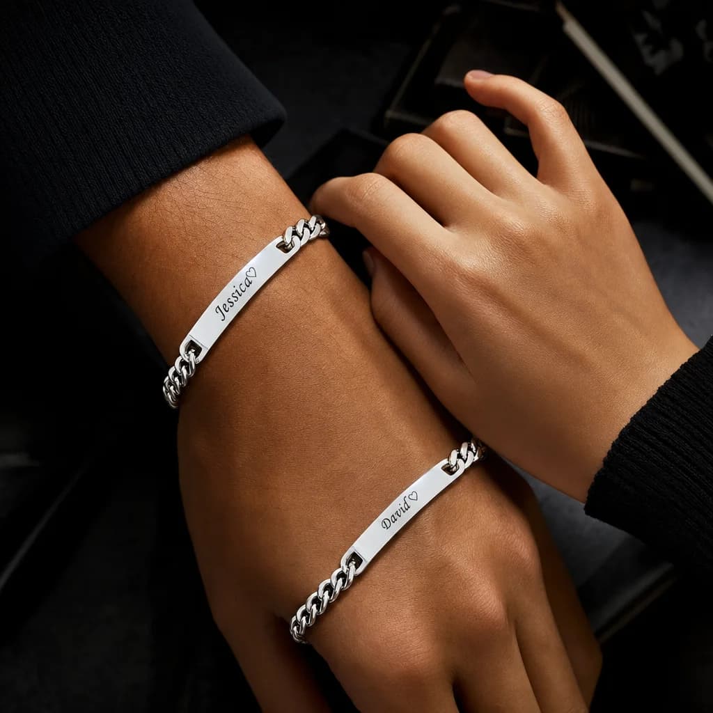Close-up of matching engraved bracelets on a couple's wrists